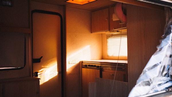 Interior of a camper van with sunlight streaming in.